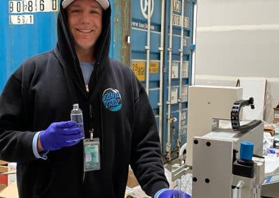 employee filling hand sanitizer bottles