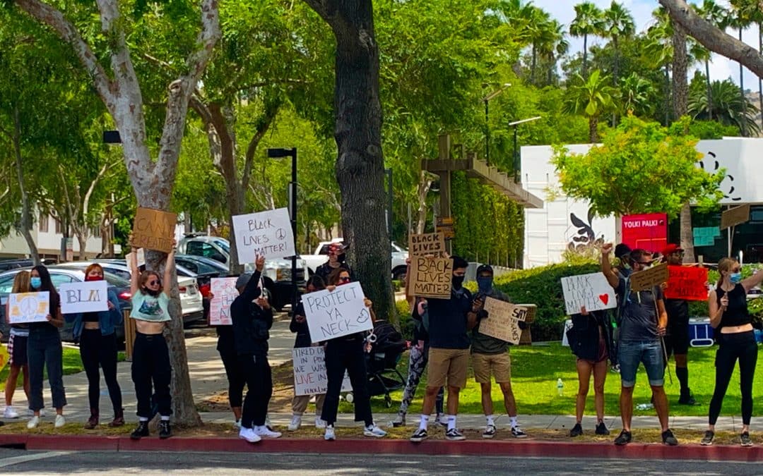 people holding signs at protest event