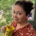 women smiling holding a mug