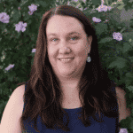 headshot of a woman outside by flowers